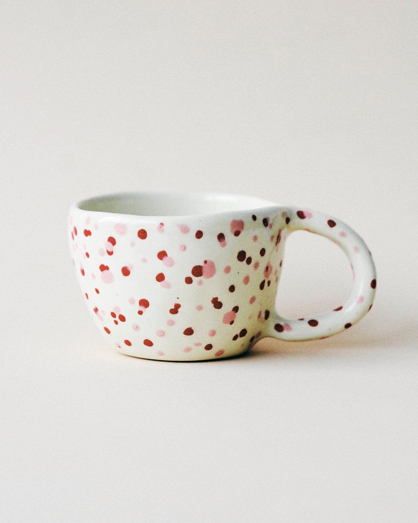 Handmade mushroom coffee cup with a cute red polka dot design, great for sipping matcha, chai, and reishi-infused lattes.